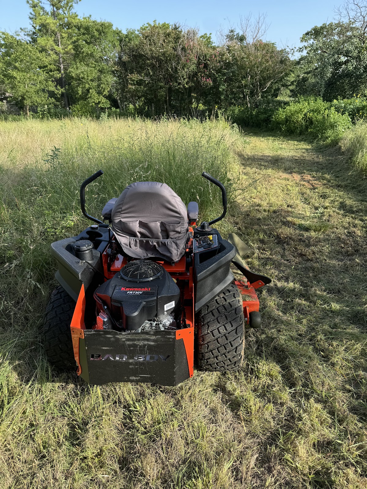 A zero-turn mower out in an open Hill Country field