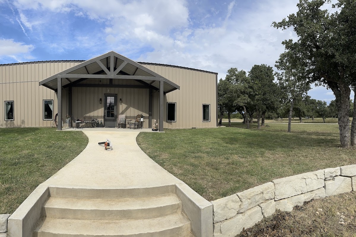 A manicured Hill Country lawn with a curved stone pathway